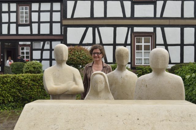 Die Steinbildhauerin Christine Jasmin Niederdorfer inmitten der von ihr geschaffenen Figuren des Opferdenkmal. Die 7. Figur ist rechts zu sehen. (Foto: Uwe Seemann) _DSC3065